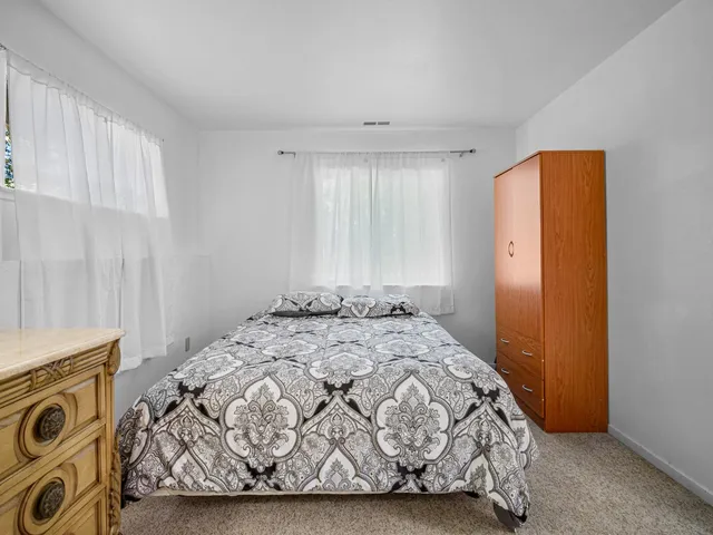 a backyard of a house with table and chairs