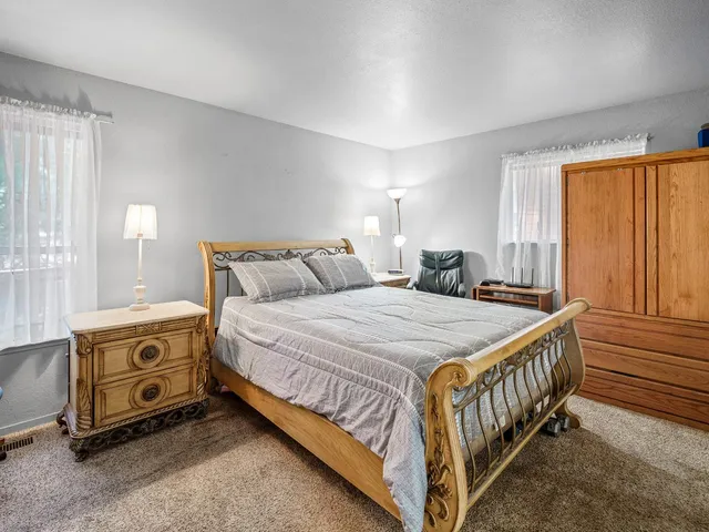 a bedroom with a bed and a night stand