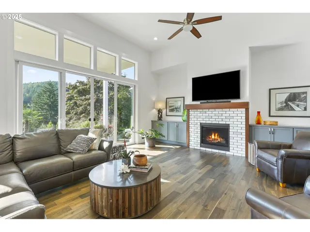 a living room with furniture a flat screen tv and a fireplace