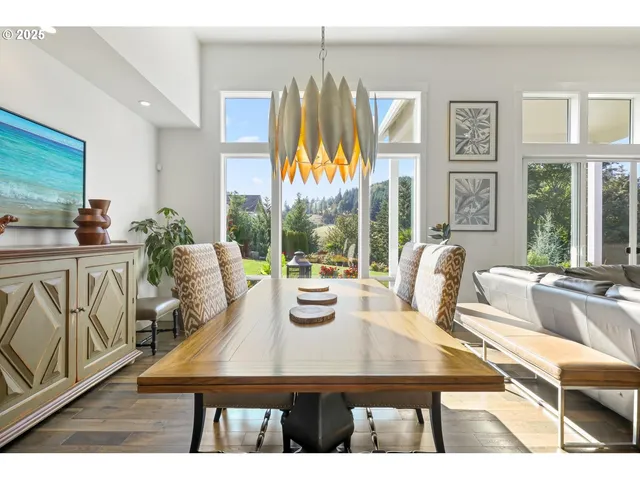 a view of a dining room with furniture large windows and wooden floor