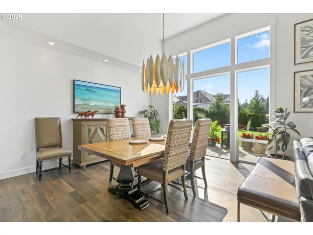 a dining room with furniture and a floor to ceiling window