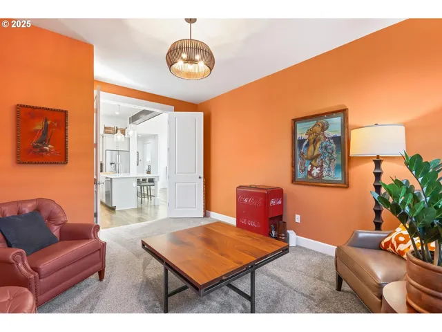 a living room with furniture a rug and a chandelier