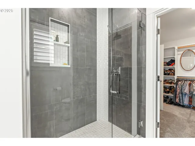 a bathroom with a shower and a sink