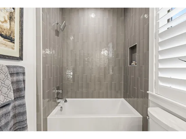 a bathroom with a tub and a shower