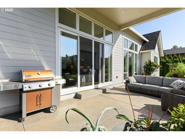 a living room with furniture a rug and white walls