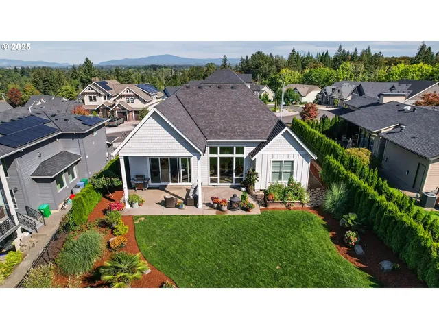a aerial view of a house with swimming pool garden and patio