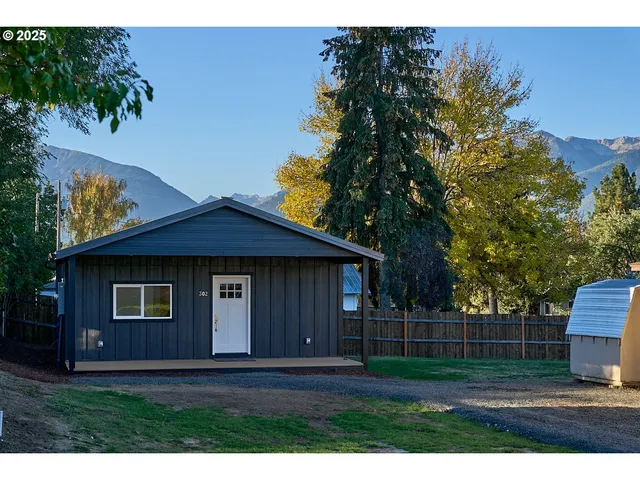a view of house with backyard space and garden