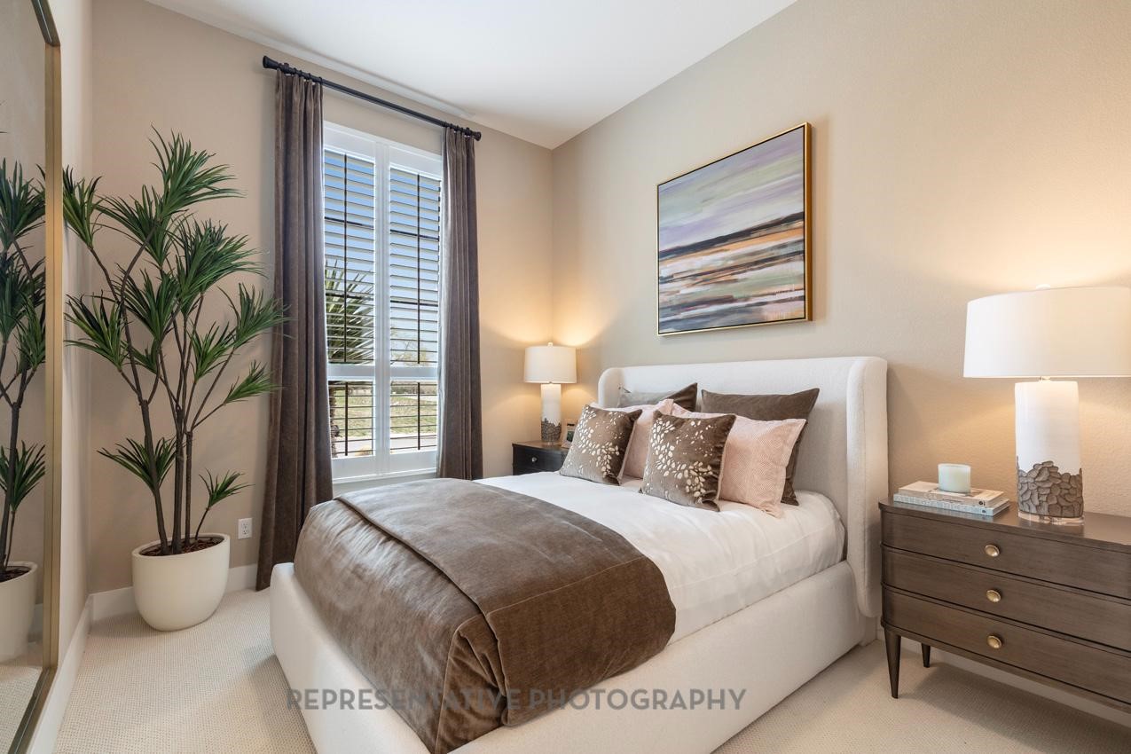 8911 Blue Grotto Lane Manvel, TX 77578 - Photo 15 of 34 a bedroom with a large bed and a potted plant