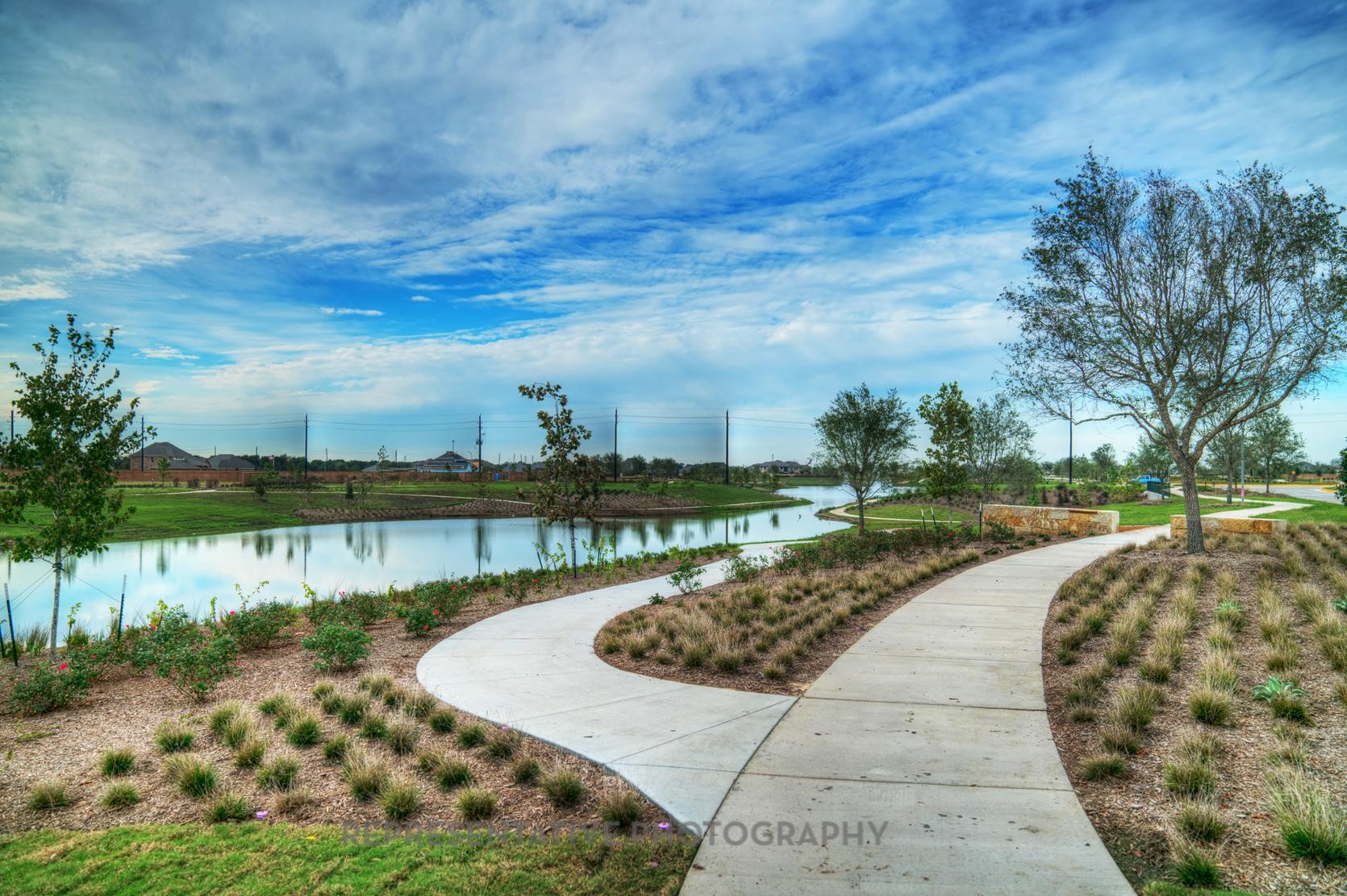 8911 Blue Grotto Lane Manvel, TX 77578 - Photo 28 of 34 a view of a lake with a garden