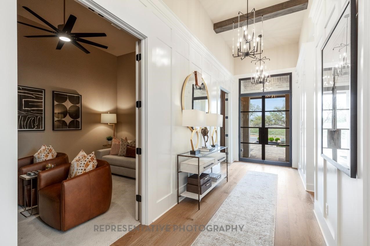 8911 Blue Grotto Lane Manvel, TX 77578 - Photo 3 of 34 a living room with furniture and a chandelier