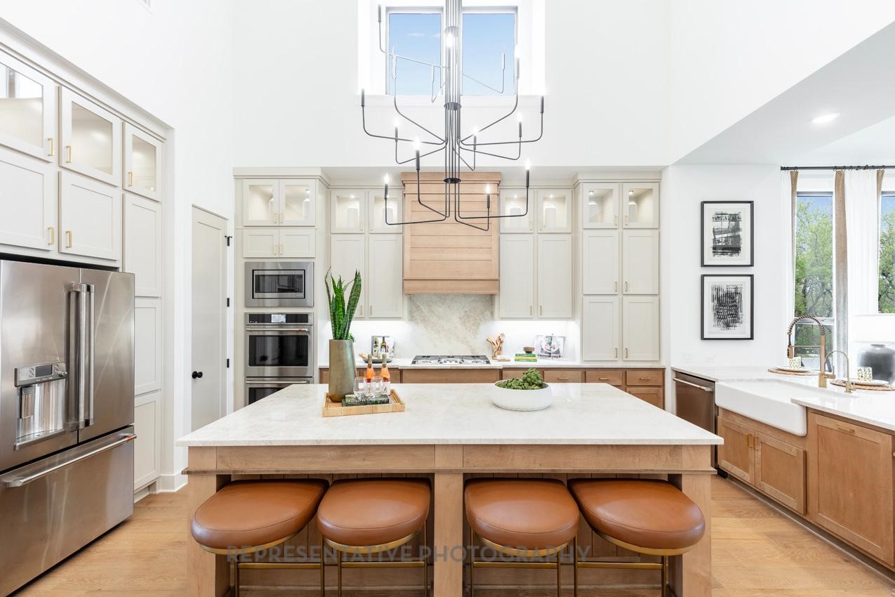 8911 Blue Grotto Lane Manvel, TX 77578 - Photo 6 of 34 a kitchen with a dining table and chairs