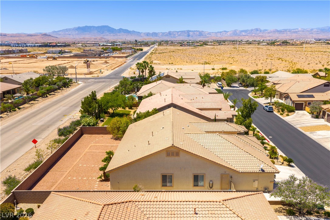 3661 Riley Ann Avenue Las Vegas, NV 89139 - Photo 40 of 42 An aerial panorama reveals a residential area with a clear view of the surrounding desert landscape and distant mountains.