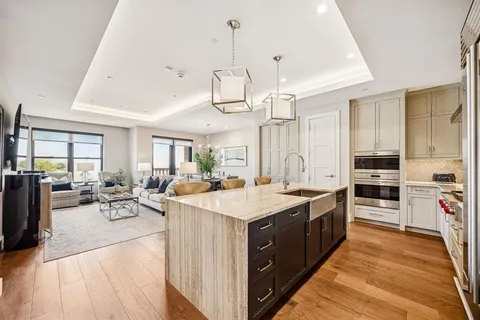 a large kitchen with stainless steel appliances a stove oven and a refrigerator with cabinets