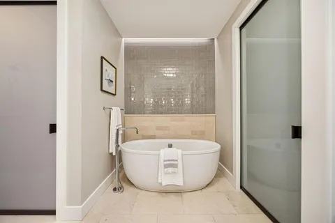 a white bath tub sitting next to a white toilet