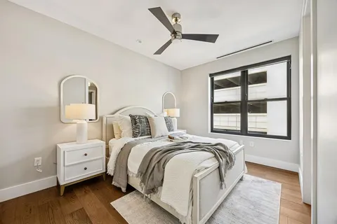 a bedroom with a bed and a large window