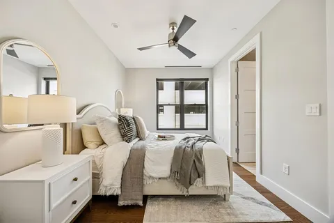 a spacious bedroom with a bed and a window