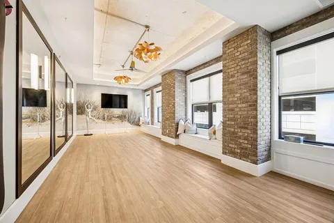 a very nice looking room with glass windows and a way to kitchen