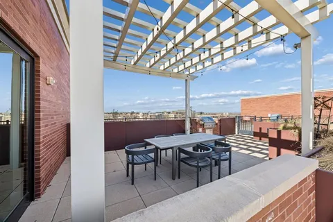 a terrace with outdoor seating and city view