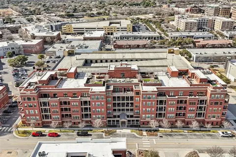 an aerial view of residential building and trees