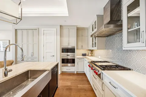 a kitchen with stainless steel appliances granite countertop a stove and a sink