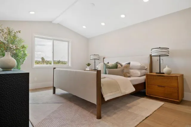 a spacious bathroom with a granite countertop sink mirror and shower