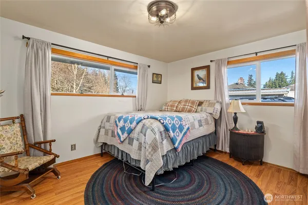 a bedroom with a bed and glass window