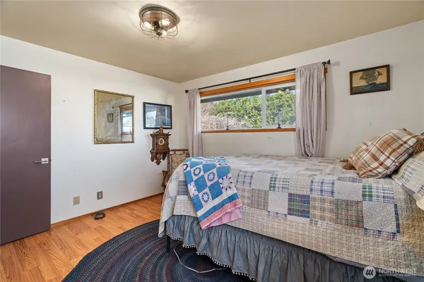 a bedroom with furniture and a window
