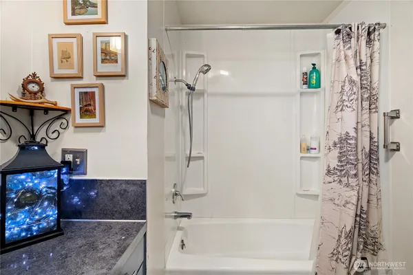 a bathroom with a bathtub and shower