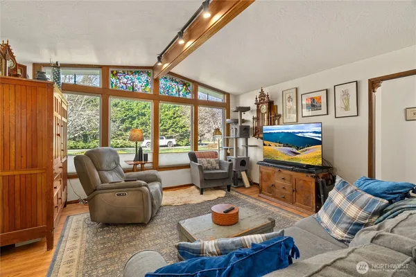 a living room with furniture and a floor to ceiling window