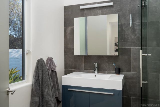 a view of a swimming pool with a lawn chairs under palm trees