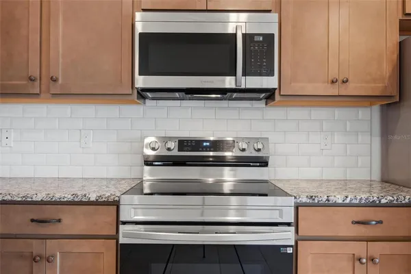 a view of a granite countertop kitchen island with a large window
