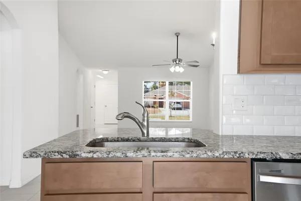a kitchen with granite countertop stainless steel appliances and white cabinets