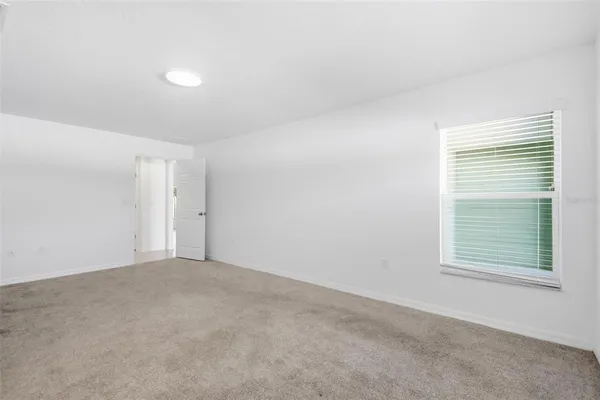 a bathroom with a granite countertop sink a toilet and a mirror