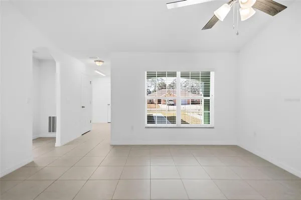 a view of a chandelier fan and entryway