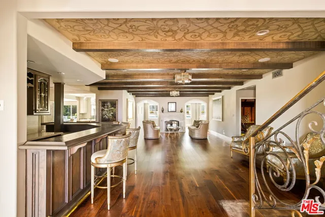 a living room with furniture a fireplace and a chandelier