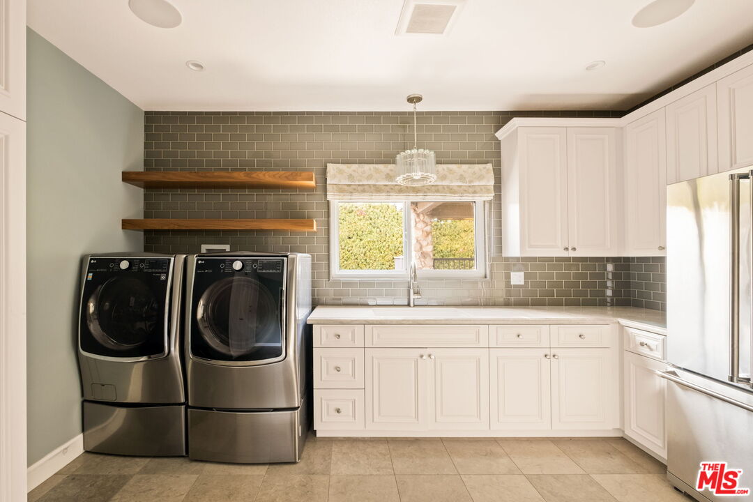 1047 East Pomello Drive Claremont, CA 91711 - Photo 35 of 73 a utility room with stainless steel appliances white cabinets and a sink