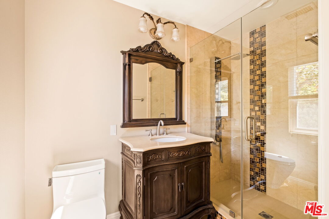 1047 East Pomello Drive Claremont, CA 91711 - Photo 39 of 73 a bathroom with a sink a mirror and a shower