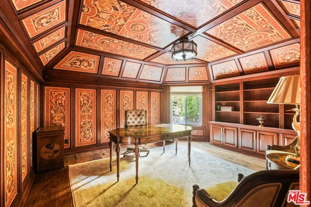 a view of a room with a chandelier fan and a window