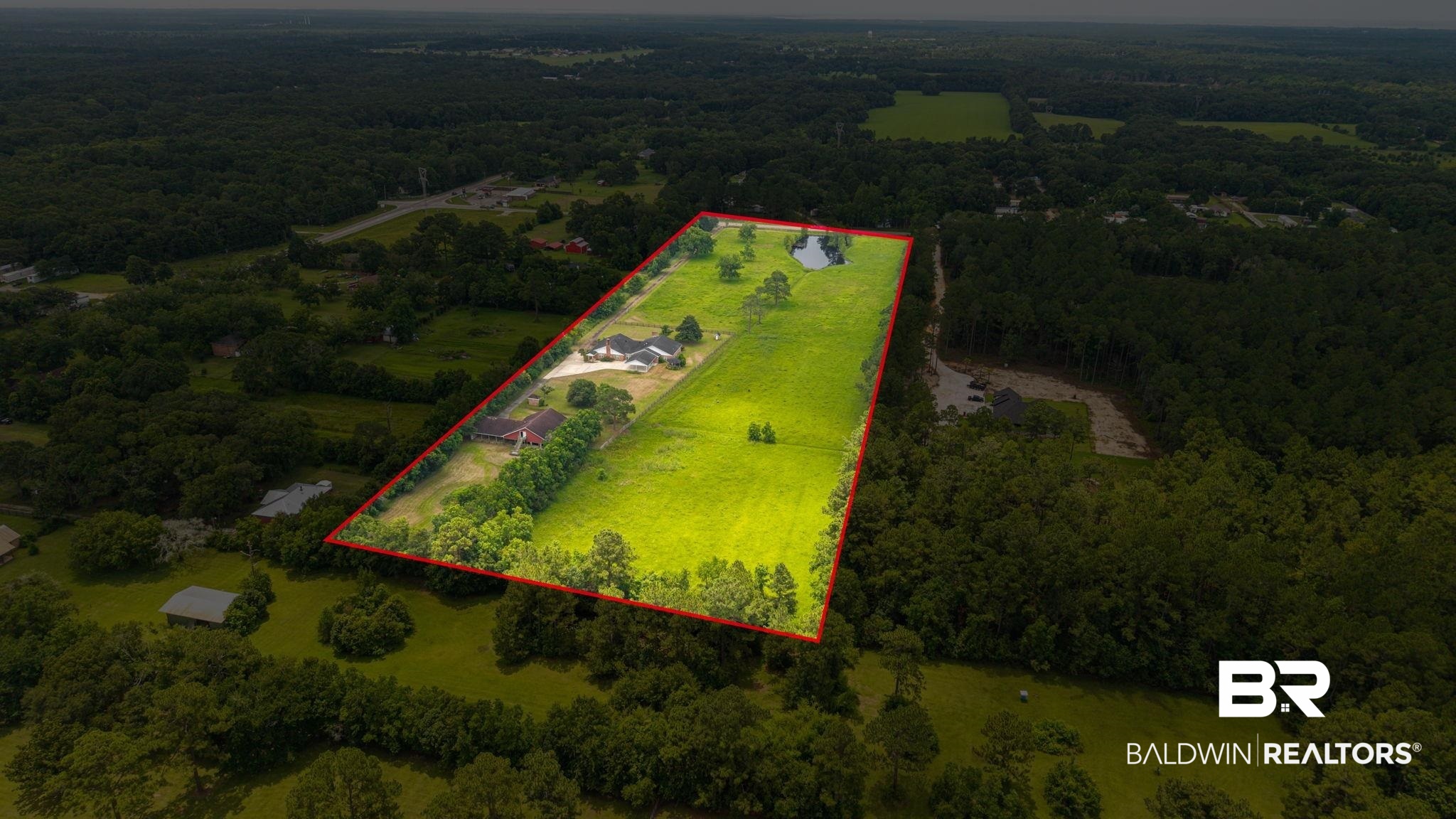 7540 2 Mile Road Irvington, AL 36544 - Photo 76 of 82 Expansive acreage featuring a private pond, two residential structures, and mature tree lines