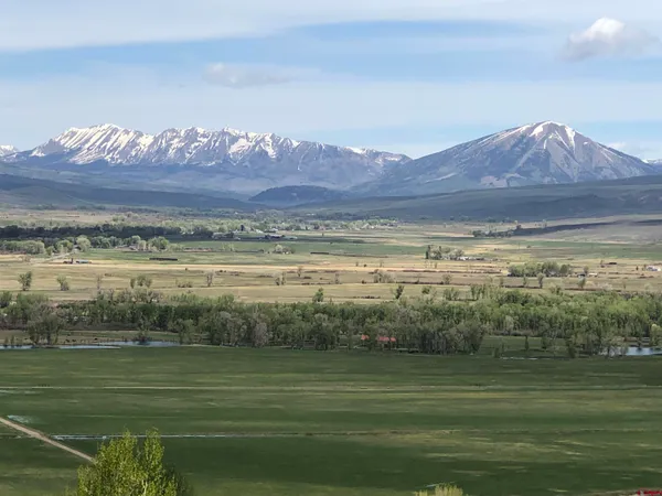 a view of a mountain with a yard