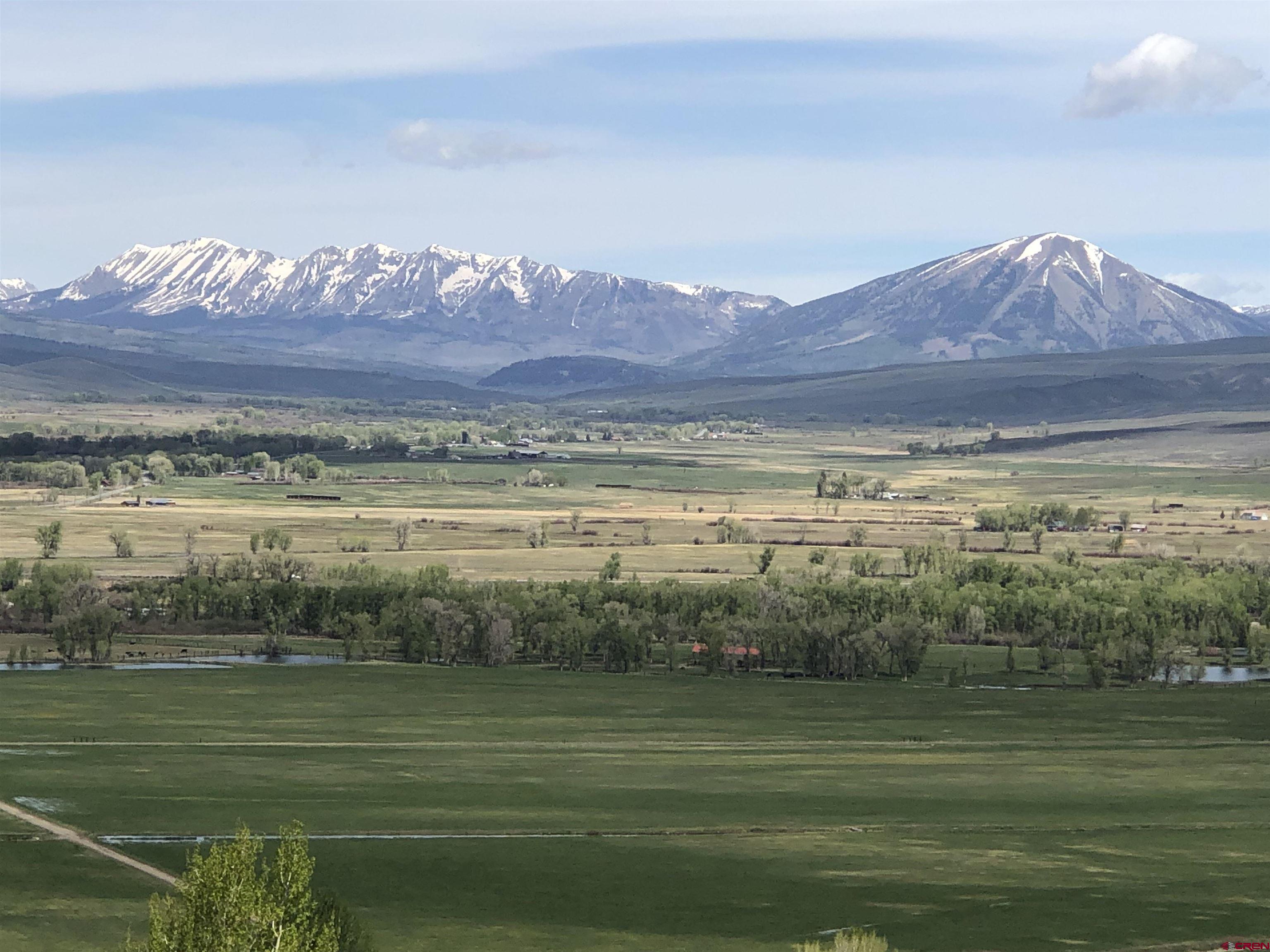 405 Sequoia Drive Gunnison, CO 81230 - Photo 16 of 26 a view of a lake with a mountain in the background