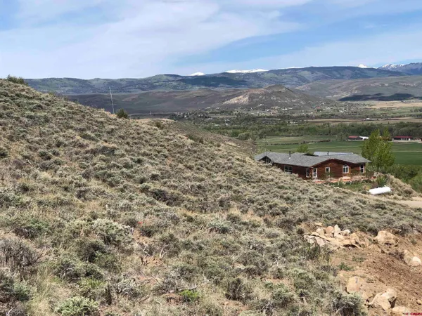 a view of a town with mountains in the background