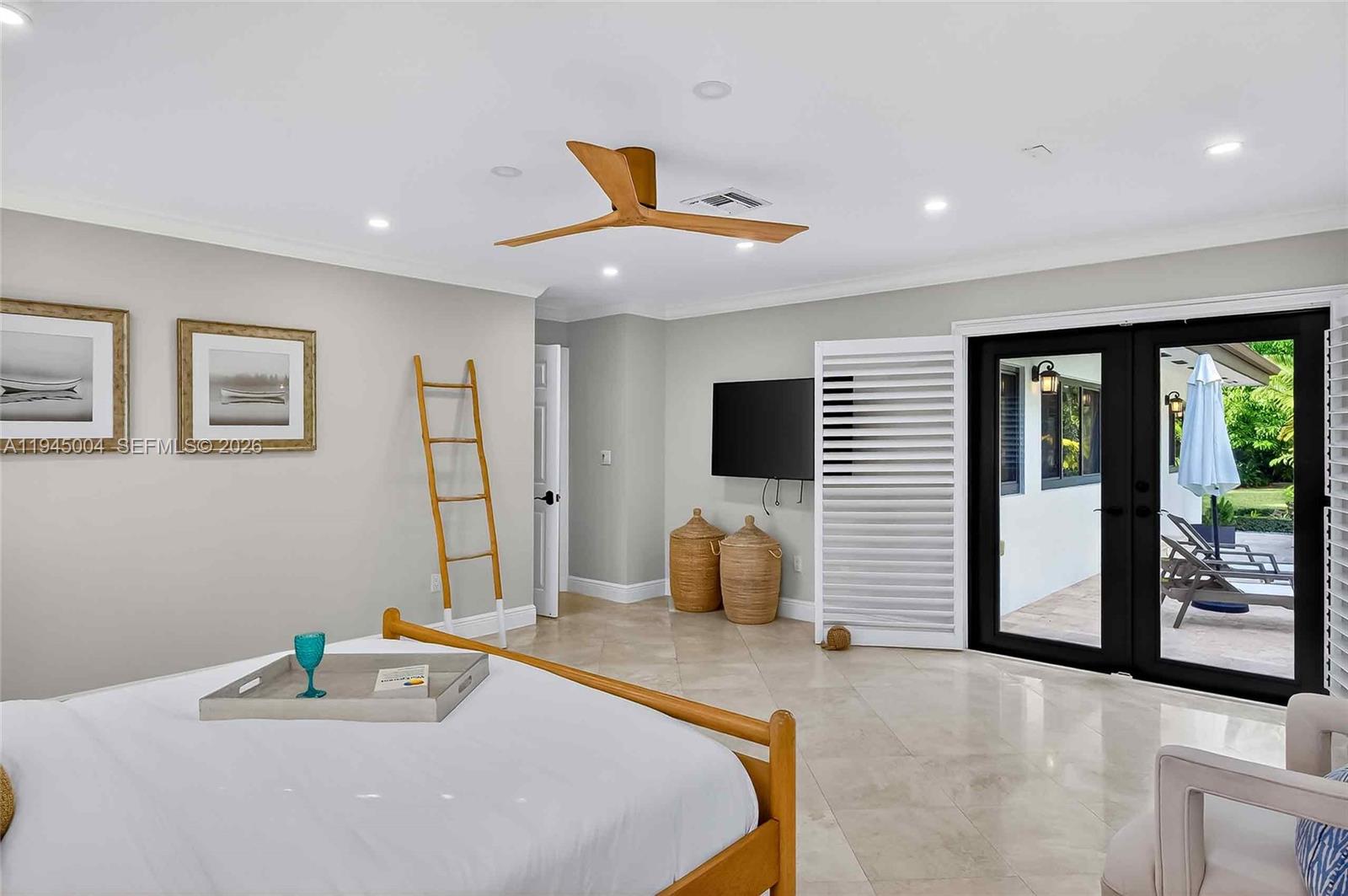 13945 North Cartee Road Palmetto Bay, FL 33158 - Photo 15 of 29 a bedroom with a bed and a flat screen tv