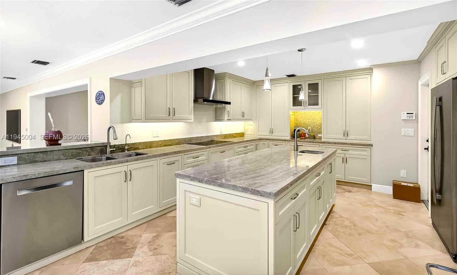 13945 North Cartee Road Palmetto Bay, FL 33158 - Photo 6 of 29 a kitchen with stainless steel appliances granite countertop a sink and cabinets