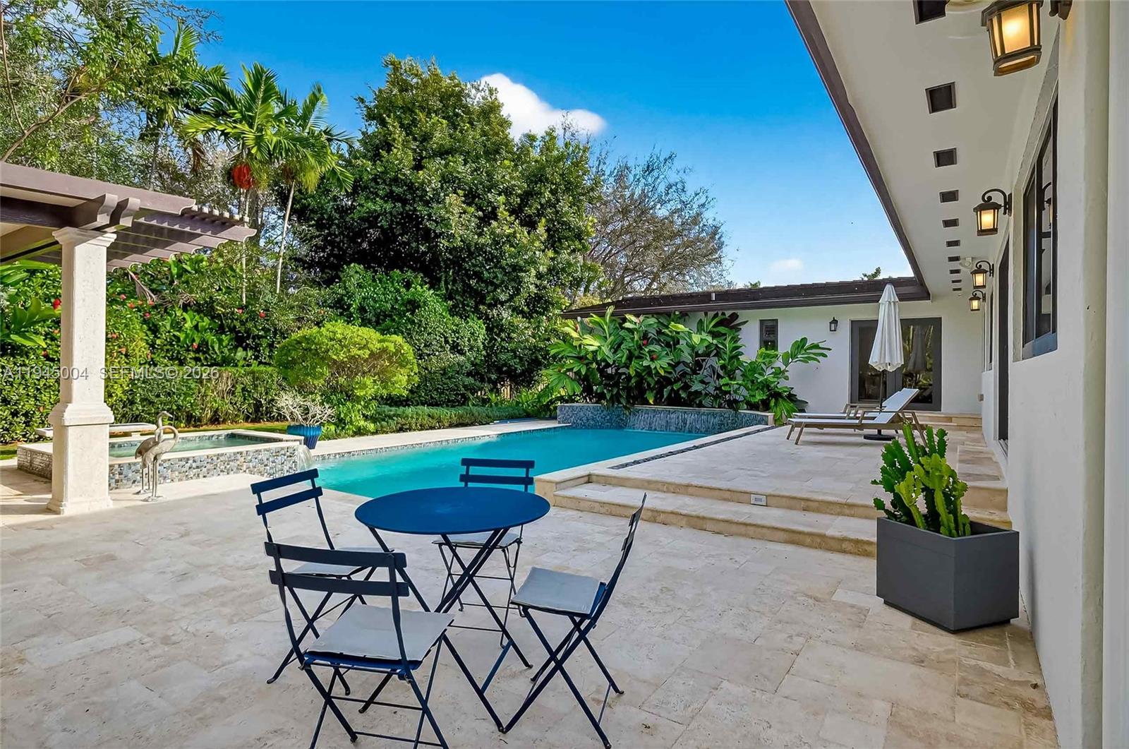 13945 North Cartee Road Palmetto Bay, FL 33158 - Photo 8 of 29 a view of a patio with table and chairs potted plants with wooden fence