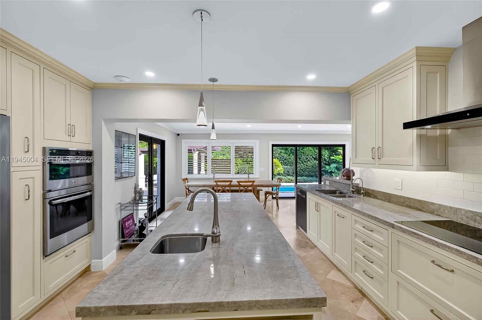 13945 North Cartee Road Palmetto Bay, FL 33158 - Photo 9 of 29 a kitchen with stainless steel appliances granite countertop a stove and a sink