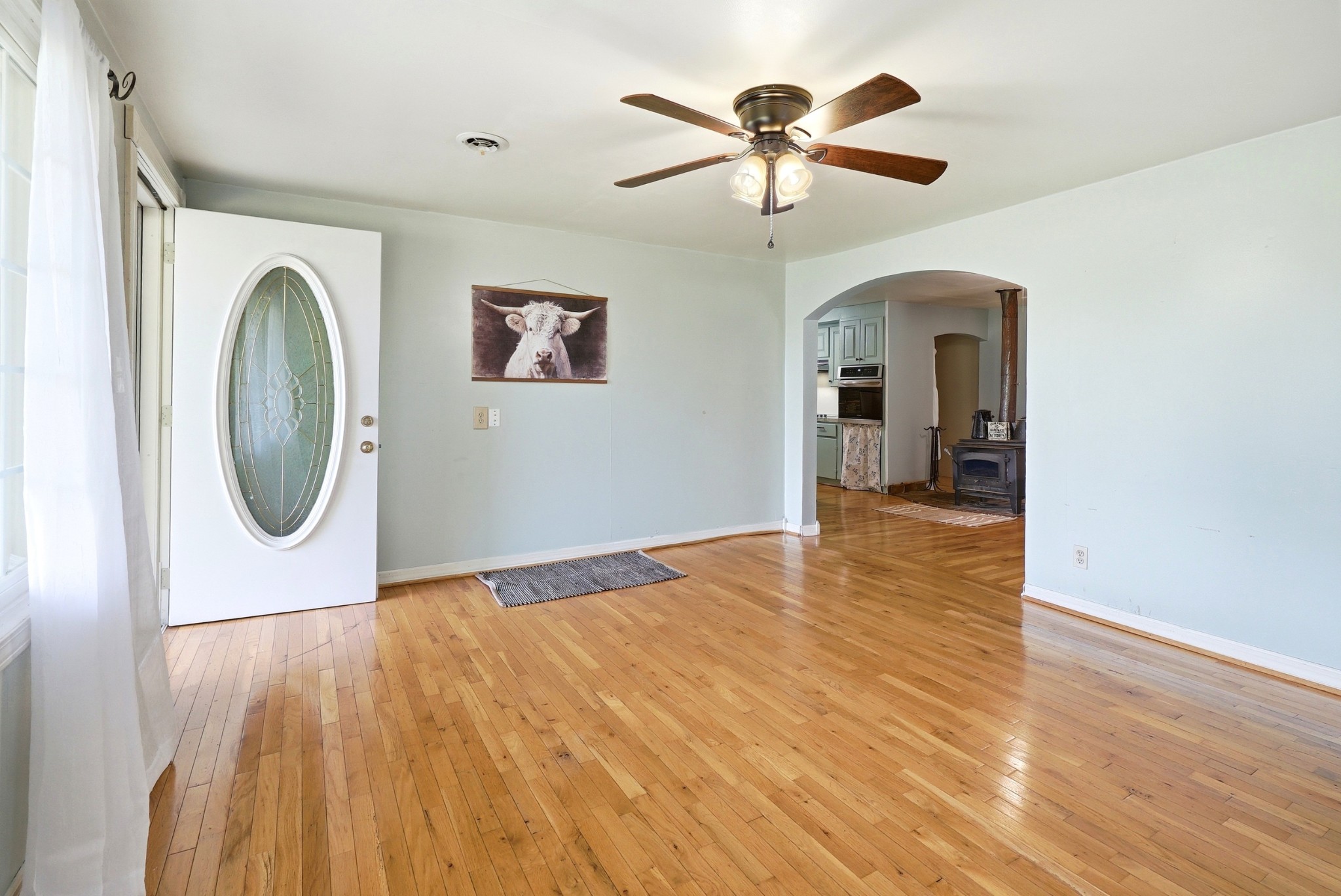 6471 Highway 161 Springfield, TN 37172 - Photo 12 of 57 a view of a big room with wooden floor and a ceiling fan