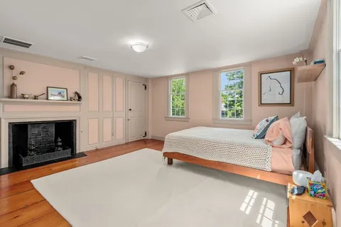 a spacious bedroom with a bed and a fireplace