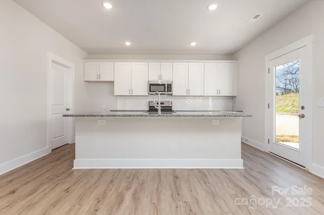 a view of kitchen with wooden floor and window