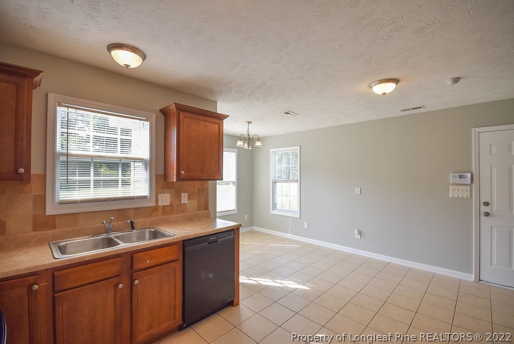 6700 Valley Falls Road Hope Mills, NC 28348 - Photo 14 of 48 a kitchen with a sink cabinets and window
